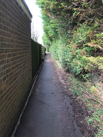Sheerstock Footpath between garden fences and trees on the border of the industrial estate